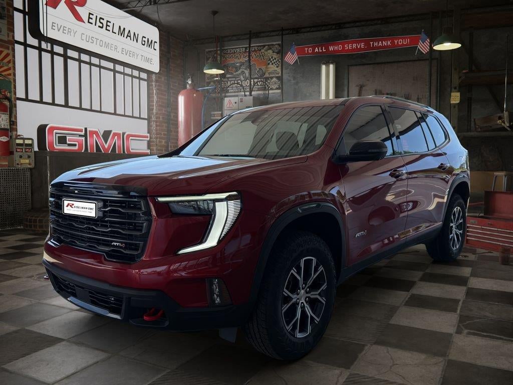 2026 GMC Acadia AT4 in Volcanic Red Tintcoat — front three-quarter view